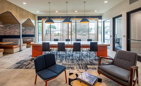 a dining area with a table and chairs in a lobby
