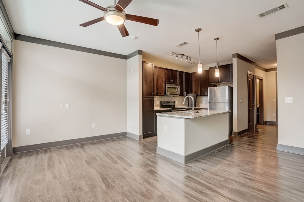 Nashville Apartments - Octave Apartments - Open concept floorplan with wood style floors granite countertops and gourmet kitchen with a large kitchen island and stainless steel appliances