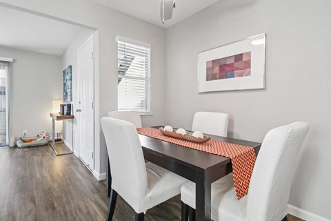 A dining room with a table set for two.