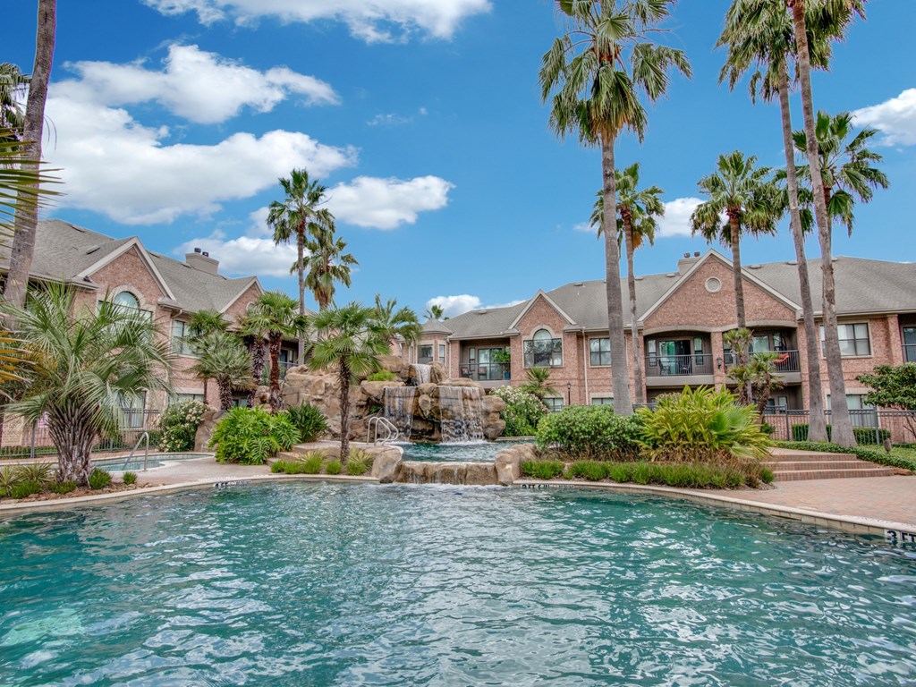 Apartments For Rent In West Houston, TX - San Montego - Tropical Lagoon Style Pool With Hot Tub, Fountains, Palm Trees, And Maintained Landscaping