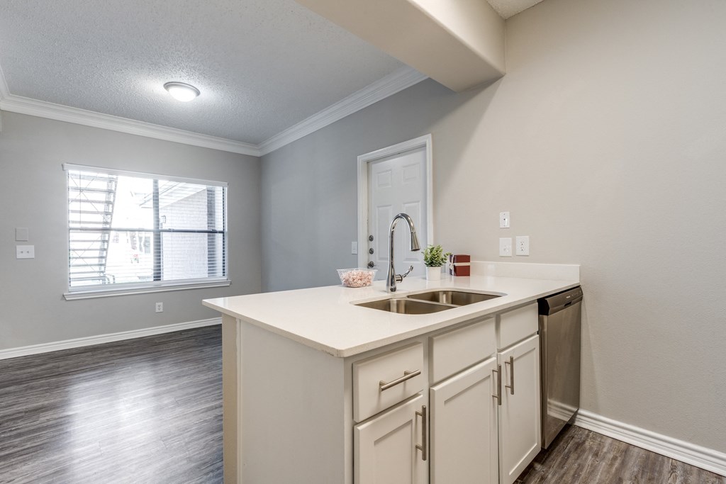 an empty kitchen with a sink and a window