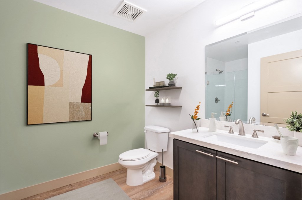 a bathroom with a sink toilet and a mirror