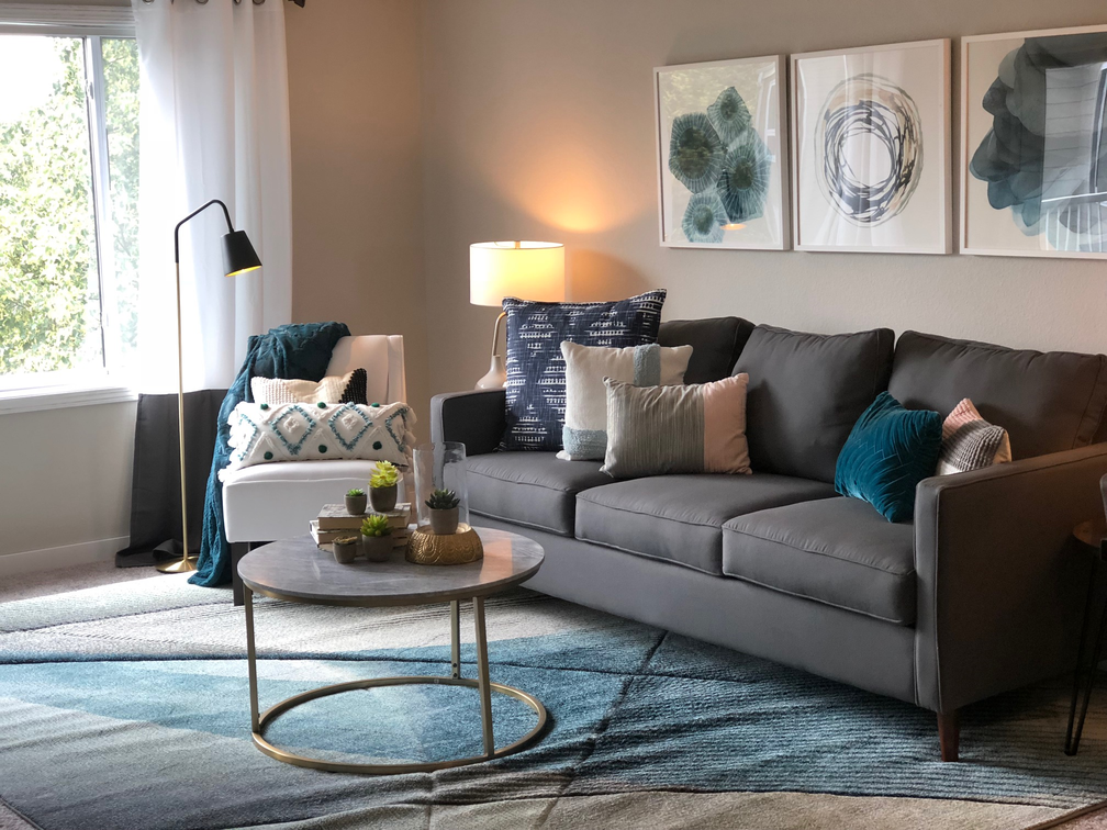 a living room with a gray couch and a coffee table