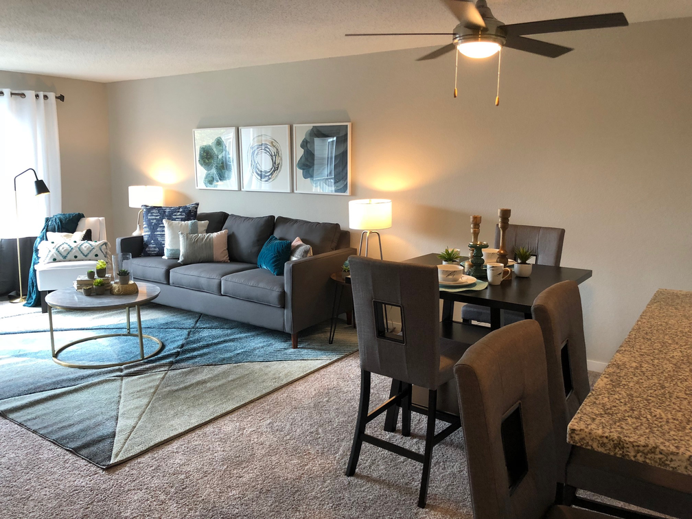 a living room and dining room with a couch and a table