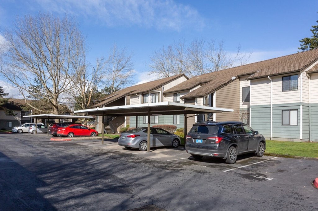 a parking lot with cars in front of a house