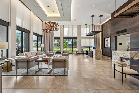 A modern living room with a large chandelier and a marble floor.