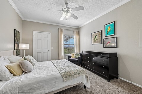 A bedroom with a large bed and a dresser.
