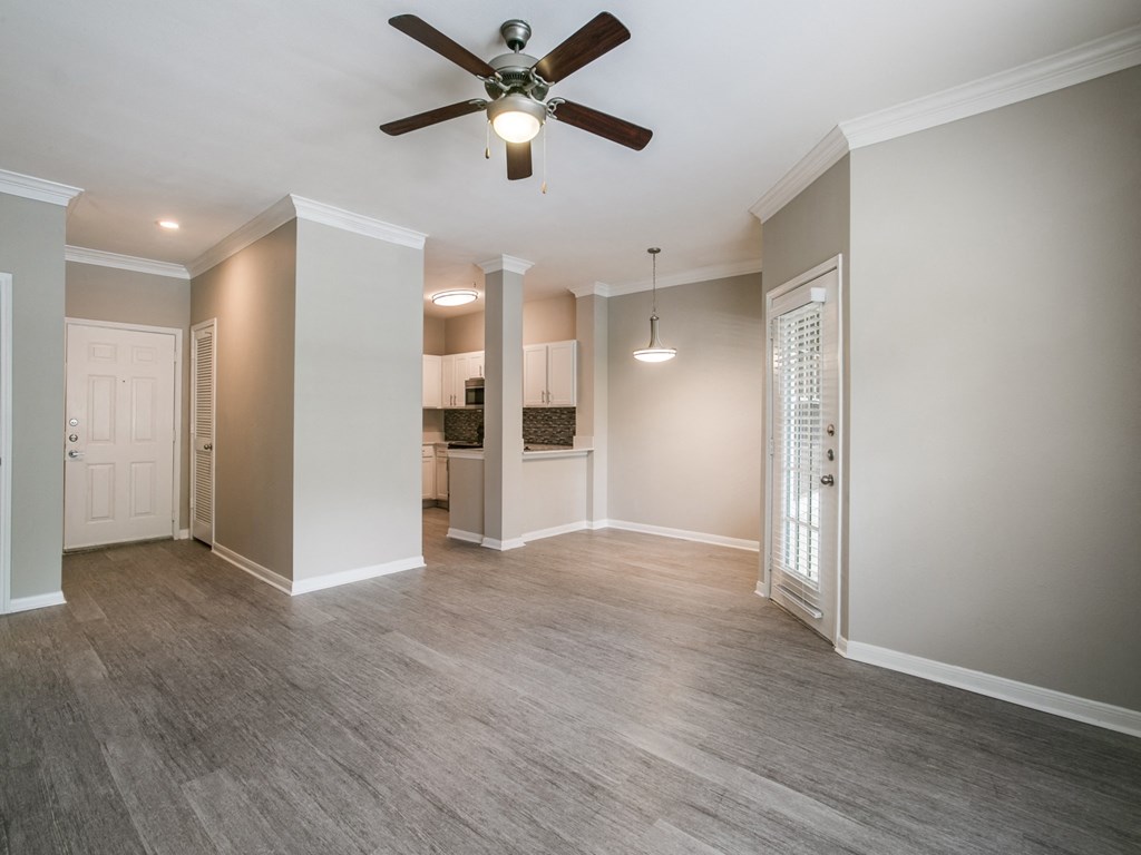Dog Friendly Apartments in Houston TX - The Maroneal - Open-Concept Living Room with Access to the Kitchen, Hardwood Flooring, and Ceiling Fan