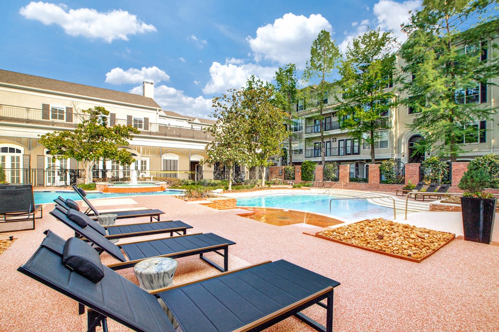 A pool area with sun loungers and a table.