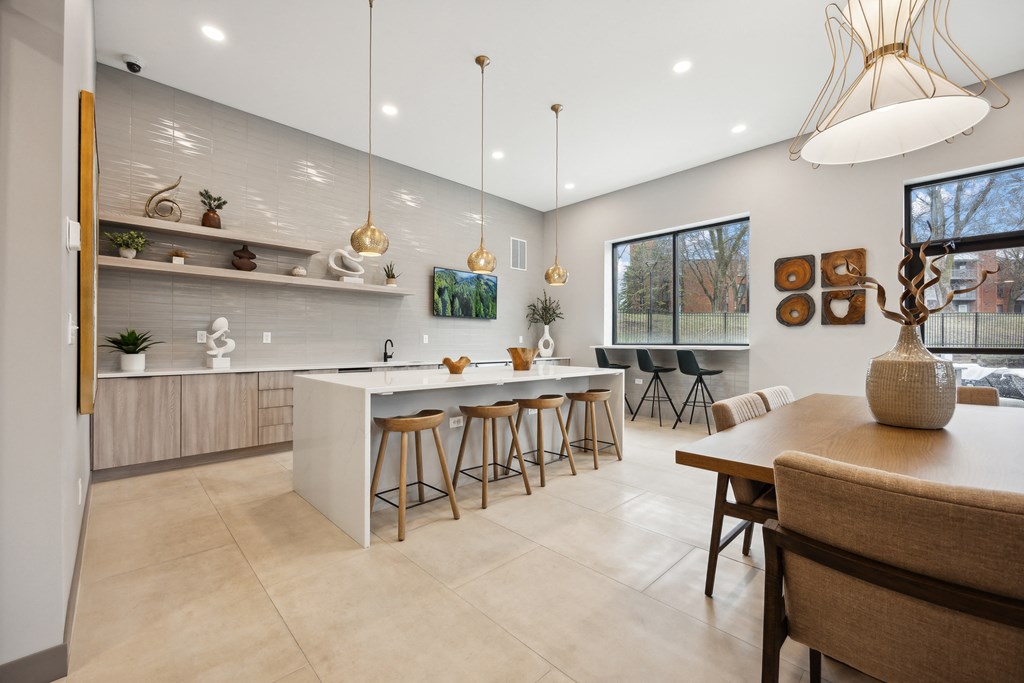 a kitchen and dining area with a table and chairs