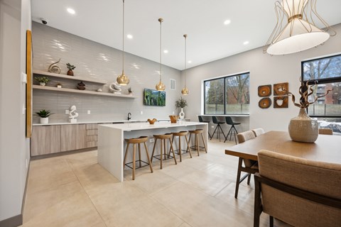 a kitchen and dining area with a table and chairs