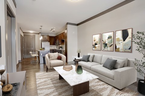 A modern living room with a grey sofa, a coffee table, and a painting on the wall.