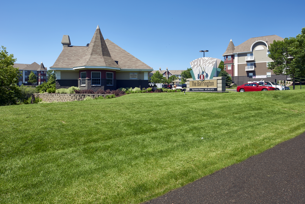 a large lawn in front of a house with a sign for a movie theater