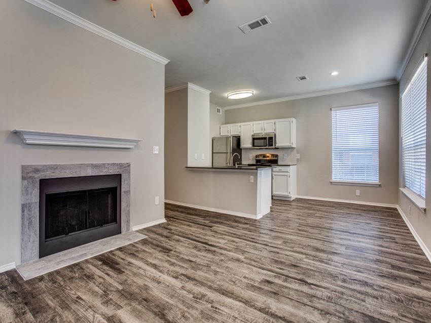 Apartments in Plano, TX - Modern Living Room with Hardwood Flooring and Access to Kitchen - Photo Gallery