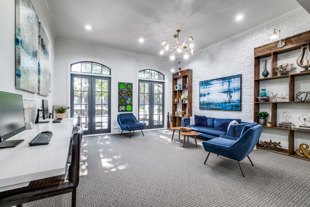 A room with a white desk and a blue chair.