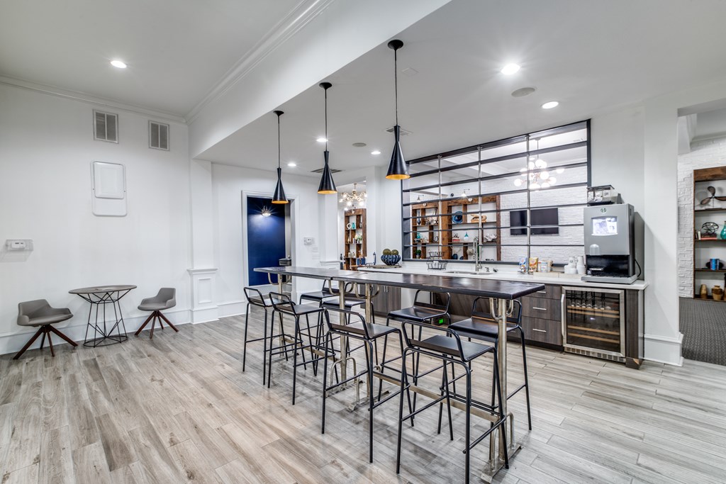 A modern kitchen with a bar area and a television.