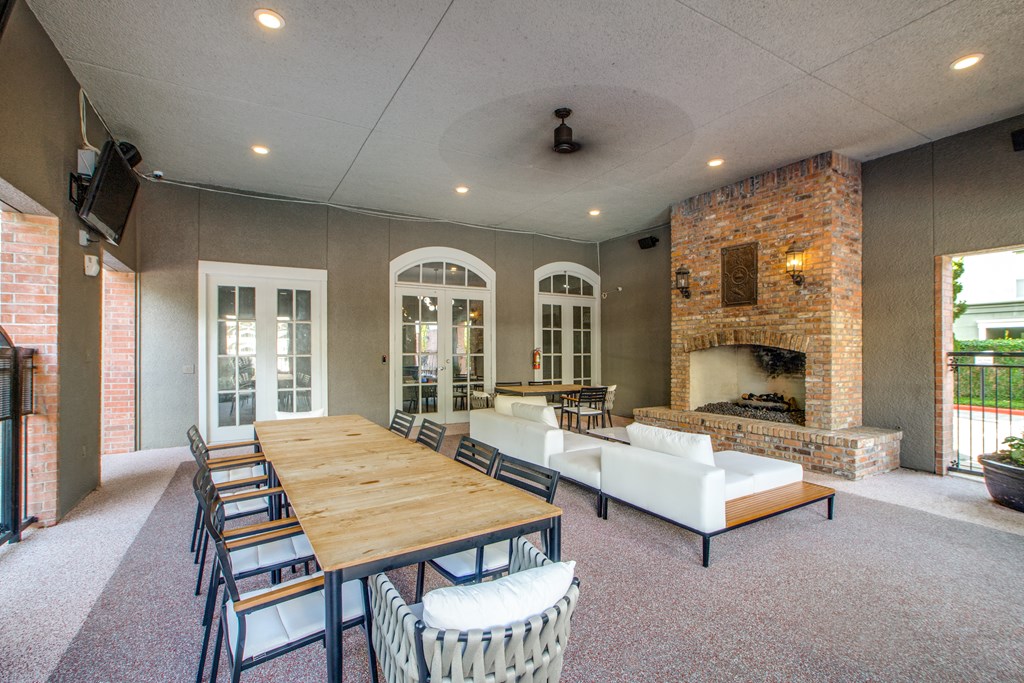 A large dining room with a long table and chairs.