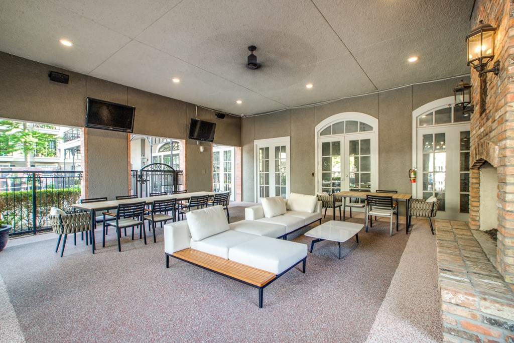 A large room with a white couch and a long table.