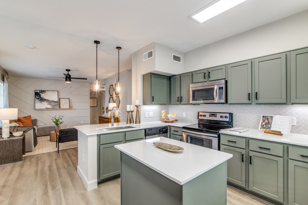 A modern kitchen with a large island in the center.