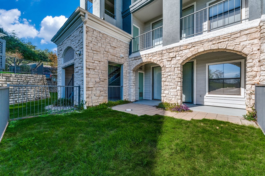 an exterior view of a house with a lawn and a walkway