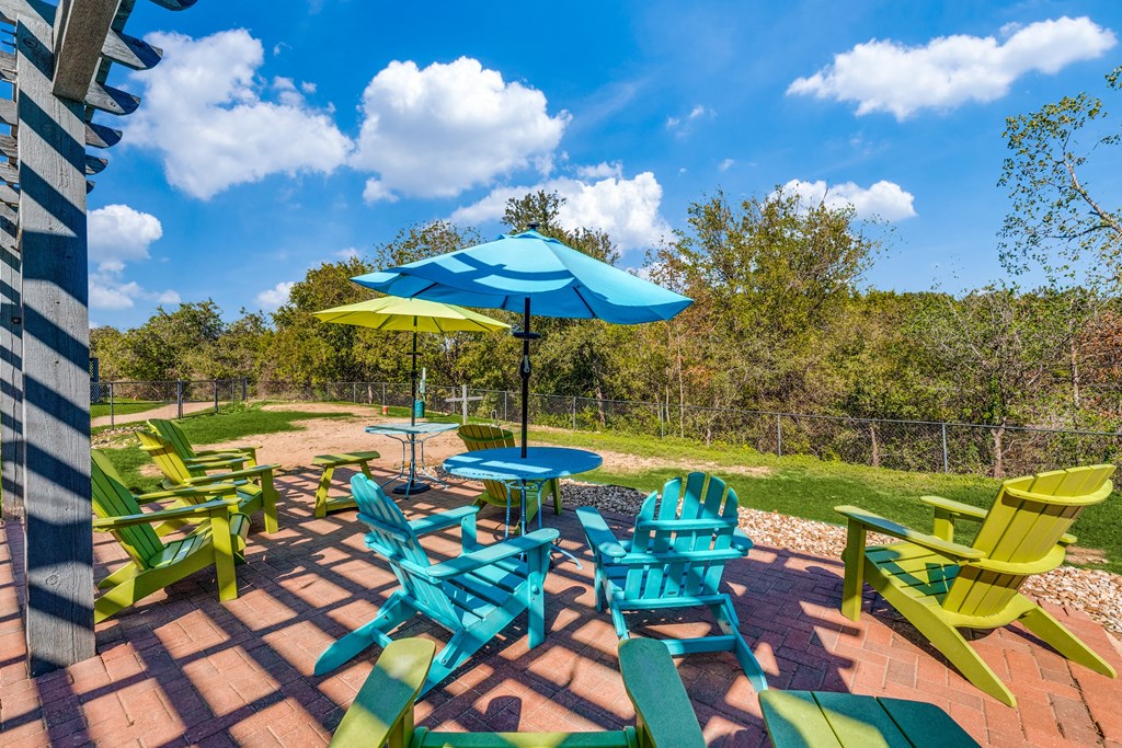 a group of colorful chairs and umbrellas on a patio