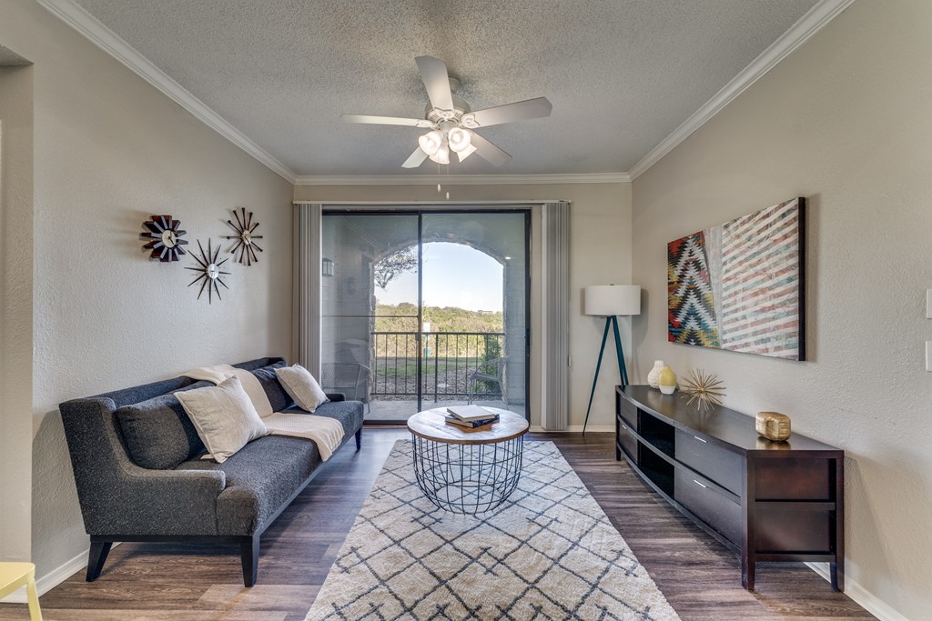 a living room with a couch and a ceiling fan