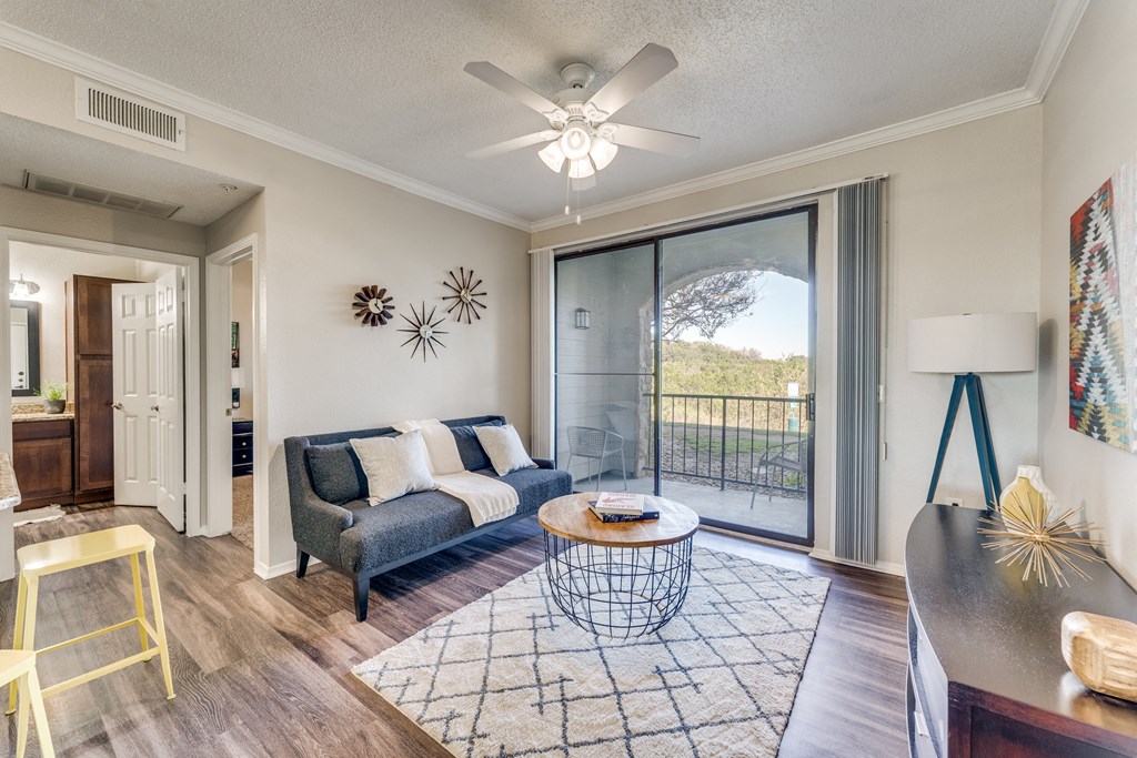 an open living room with a sliding glass door to a balcony