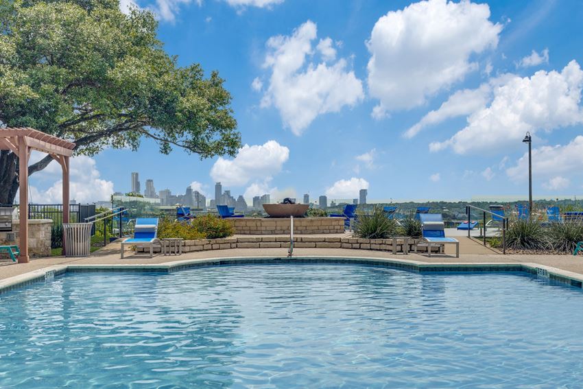 a pool with a view of the city in the background - Photo Gallery 1