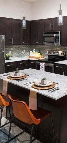 a kitchen with a large island with two plates on it