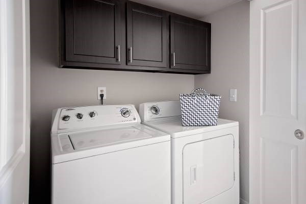 A white washing machine and dryer in a small laundry room.