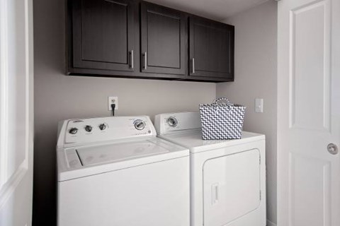 A white washing machine and dryer in a small laundry room.