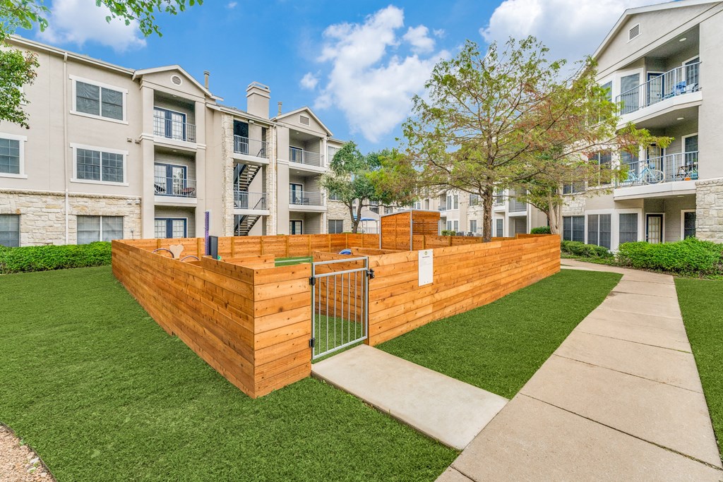 Apartments in Austin, TX - Parkside Crossing - Enclosed Dog Park with Exercise Equipment and Pet-Washing Station.