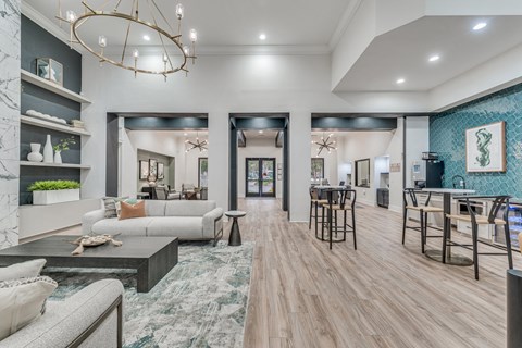 a living room and dining room with furniture and a chandelier