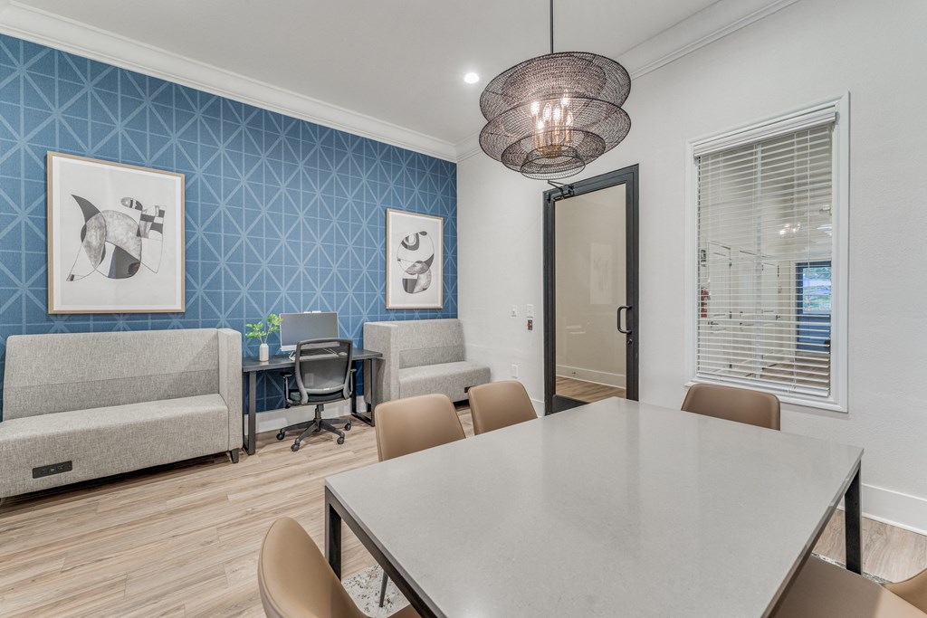 One-Bedroom Apartments in Austin, TX - Parkside Crossing - Conference Room with Table, Chairs, and Computer Workstation.