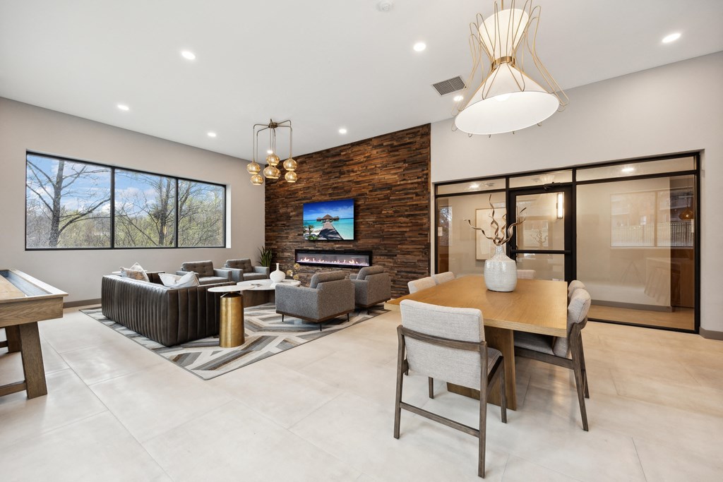 the living room and dining room in a modern home with a tv on the wall