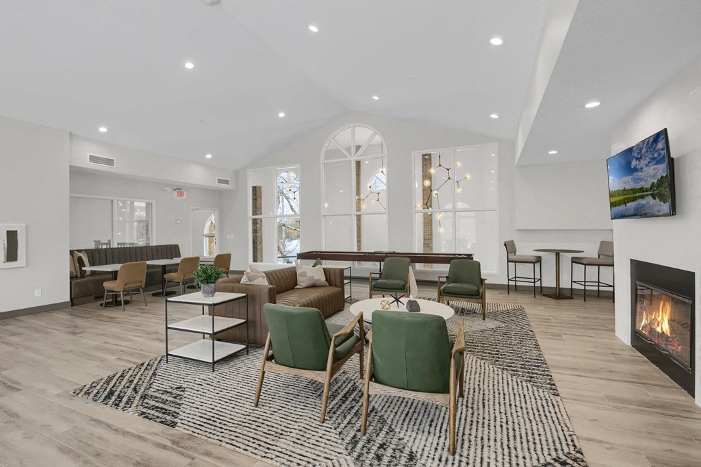 a living room with couches and chairs and a fireplace