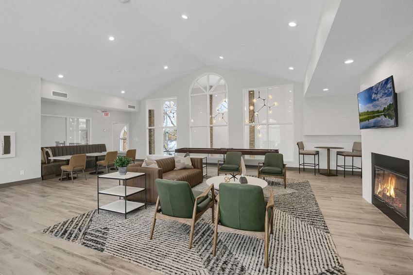 a living room with couches and chairs and a fireplace