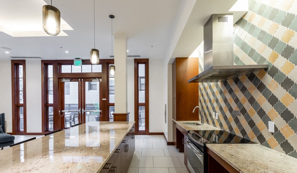 a kitchen with a large counter and a stove top oven