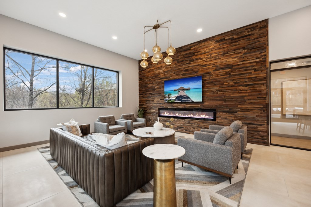 a living room with couches and chairs and a fireplace