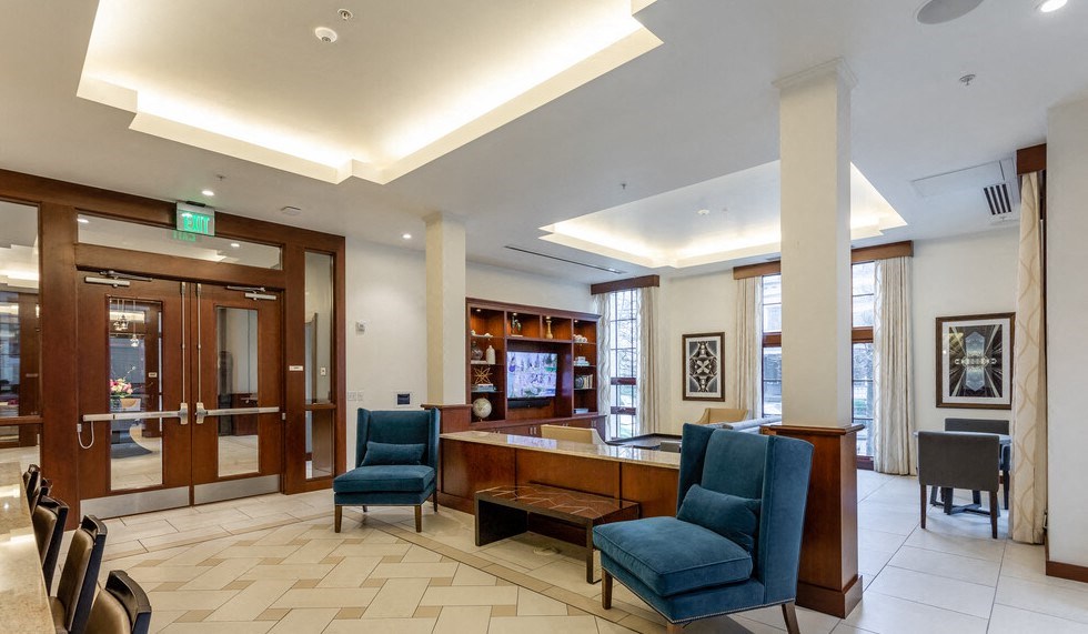 a lobby with a reception desk and chairs