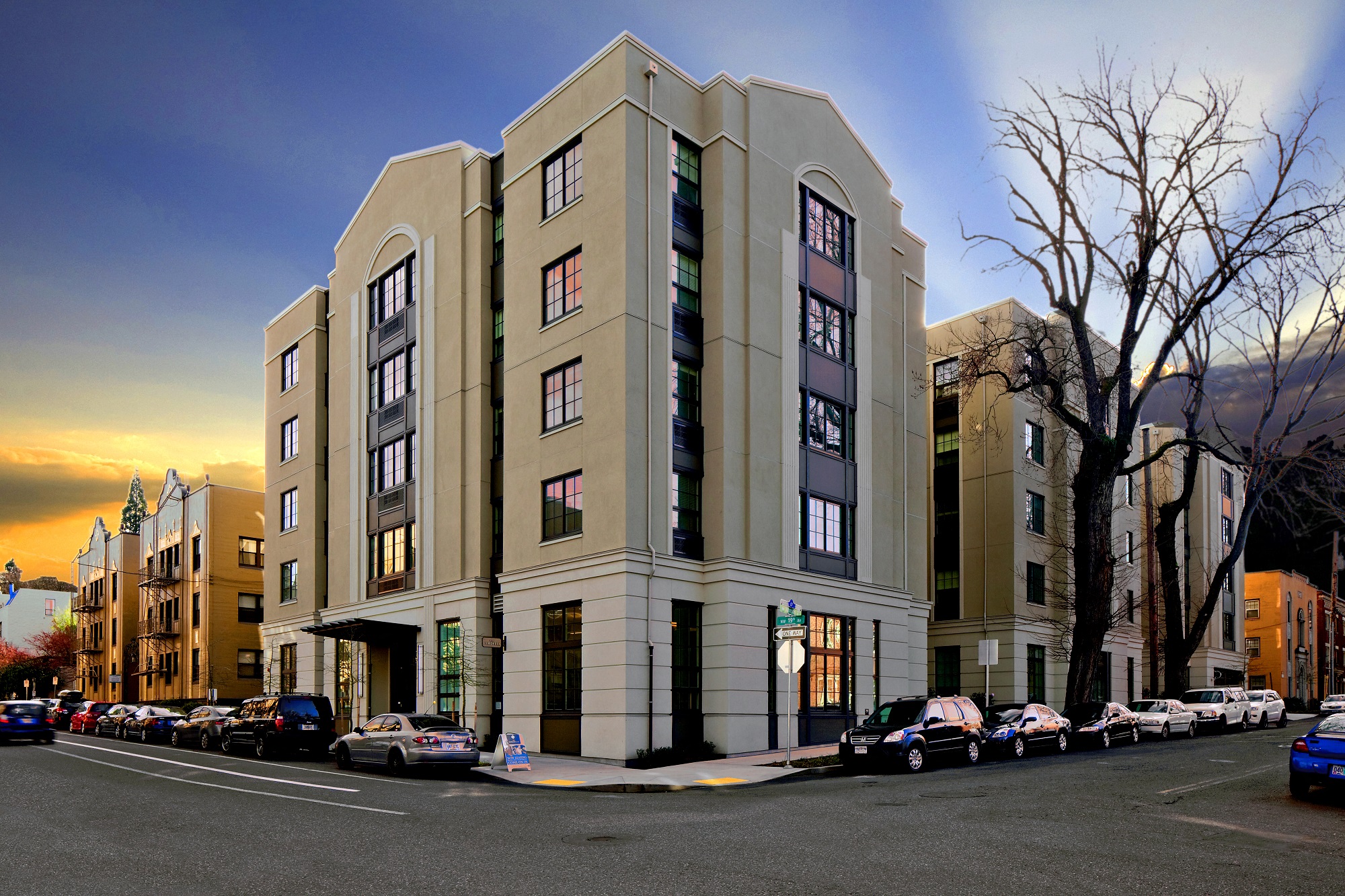 Apartments in Nob Hill Portland, OR - The Cordelia - Exterior View of Apartments Building at Dusk with Large Windows, and Sidewalks