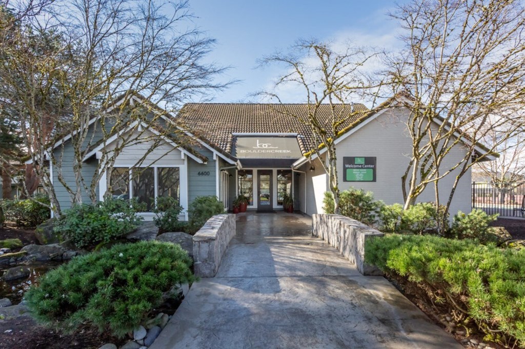 the front of a house with a walkway and a driveway to it