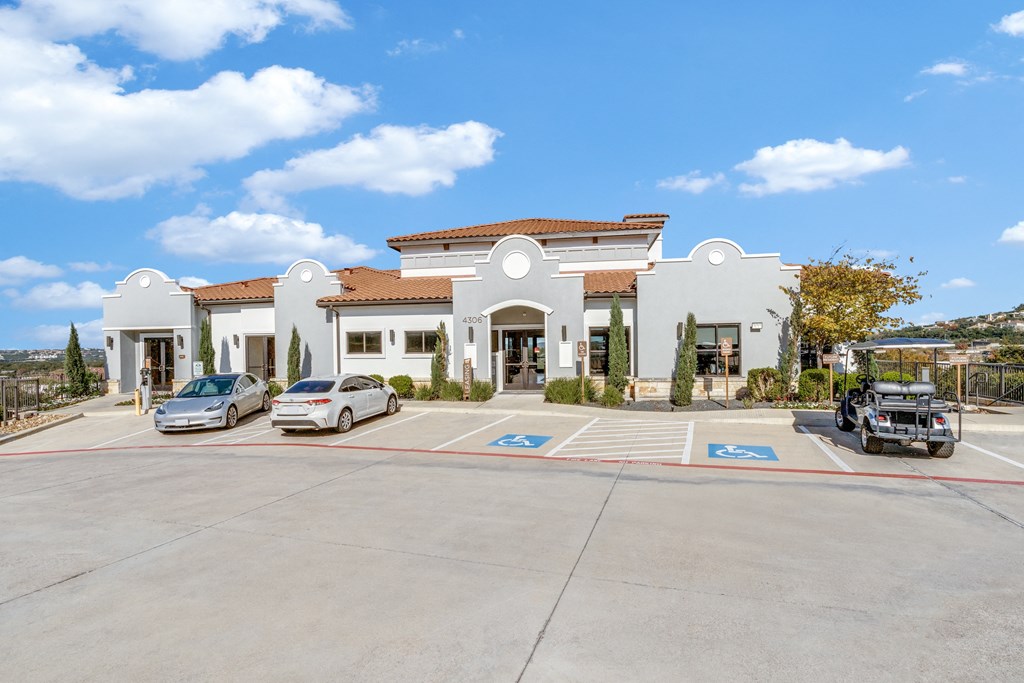 a parking lot in front of a building with cars