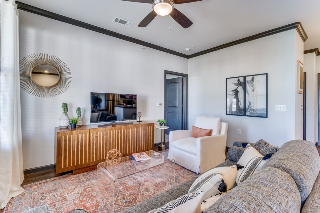 a living room with a couch and a ceiling fan