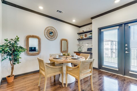 a dining room with a table and chairs and a window