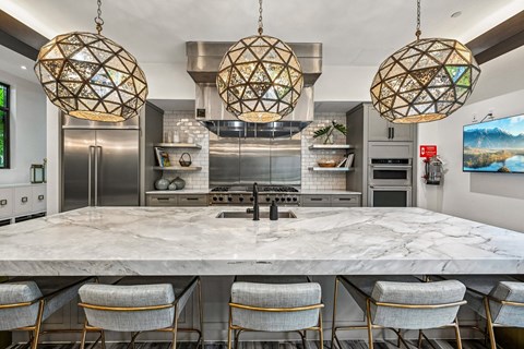 A modern kitchen with a marble table and chairs.