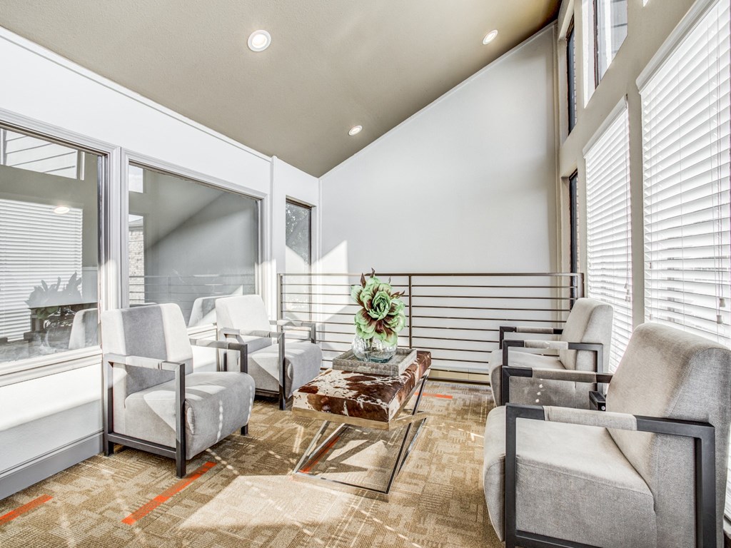 a living room with chairs and a coffee table