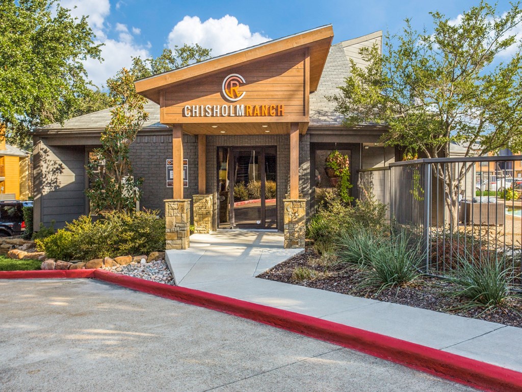 the front entrance market with trees and a sidewalk in front