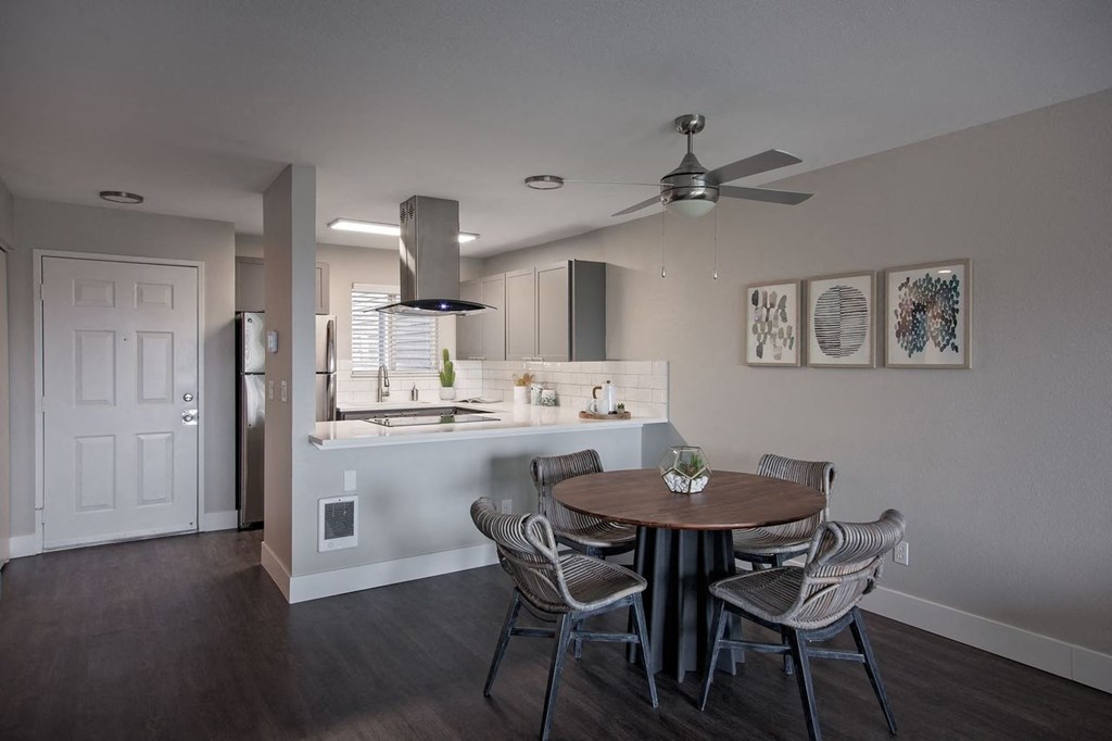a kitchen and dining room with a table and chairs