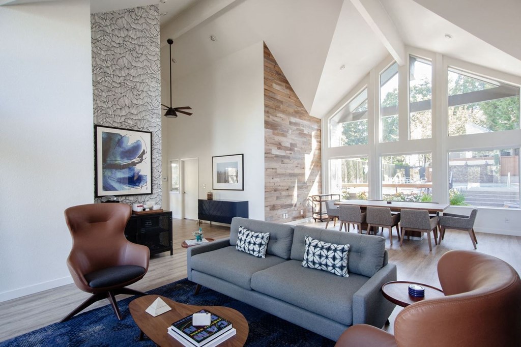 a living room with a couch and a table with chairs